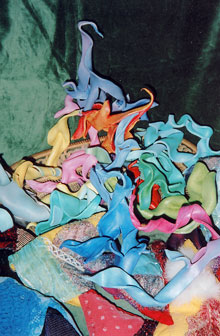 Coloured twists of leather are heaped up on a pile of beautiful bean bags.